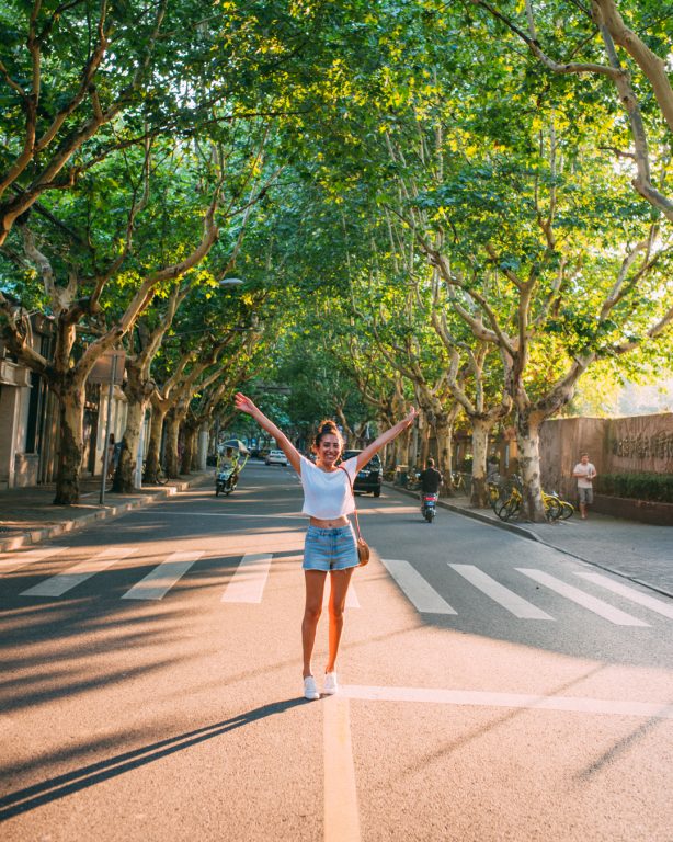 French concession street trees women open arms